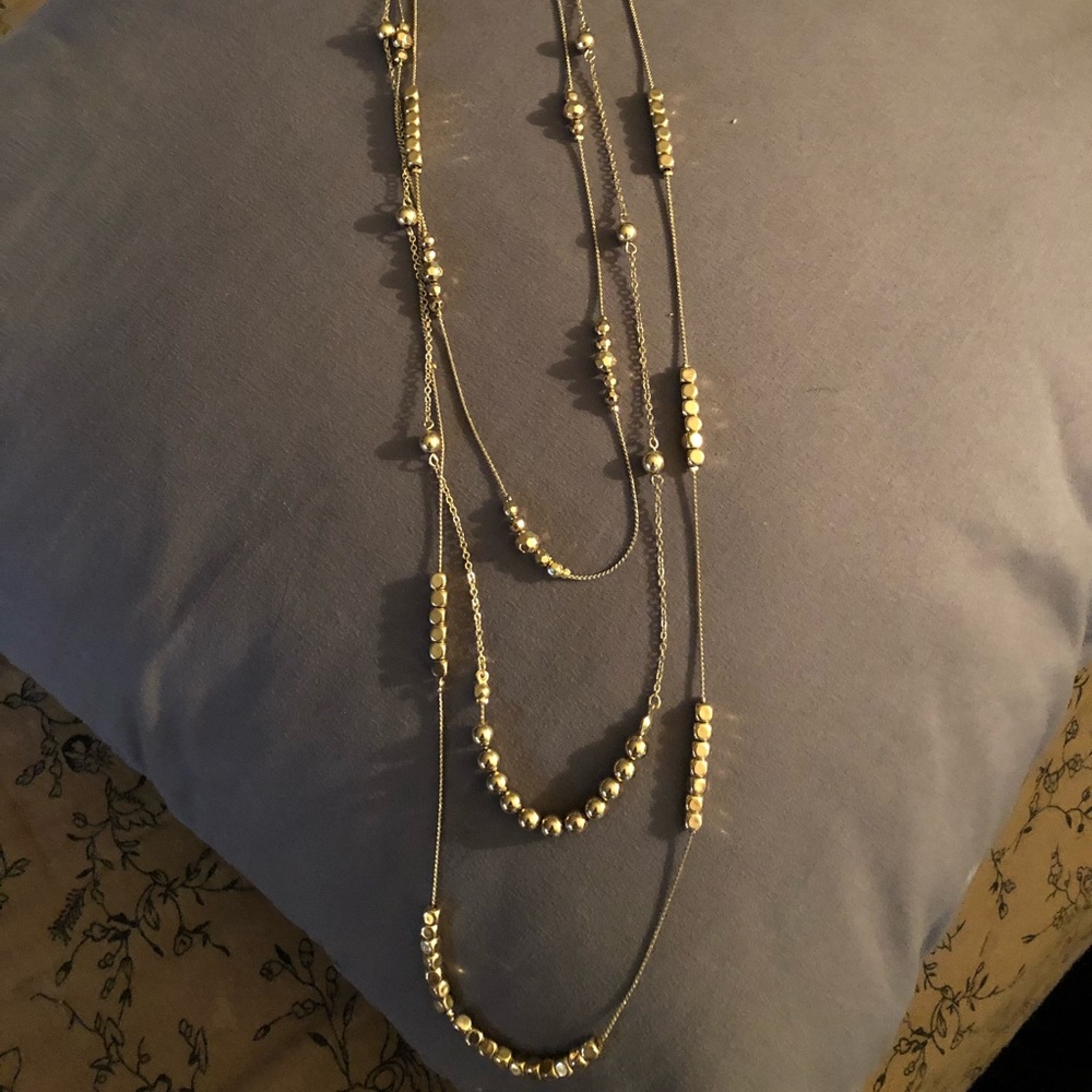 Long multi strand gold necklace